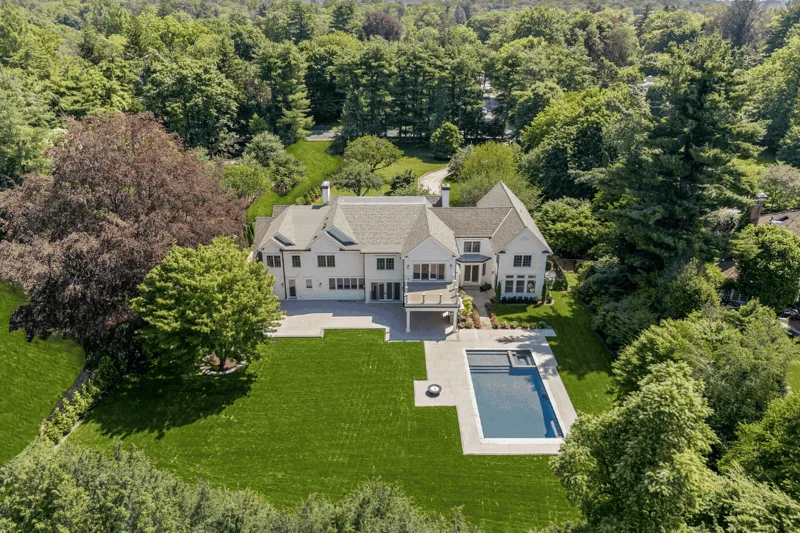 Aerial view of the property in its wooded setting